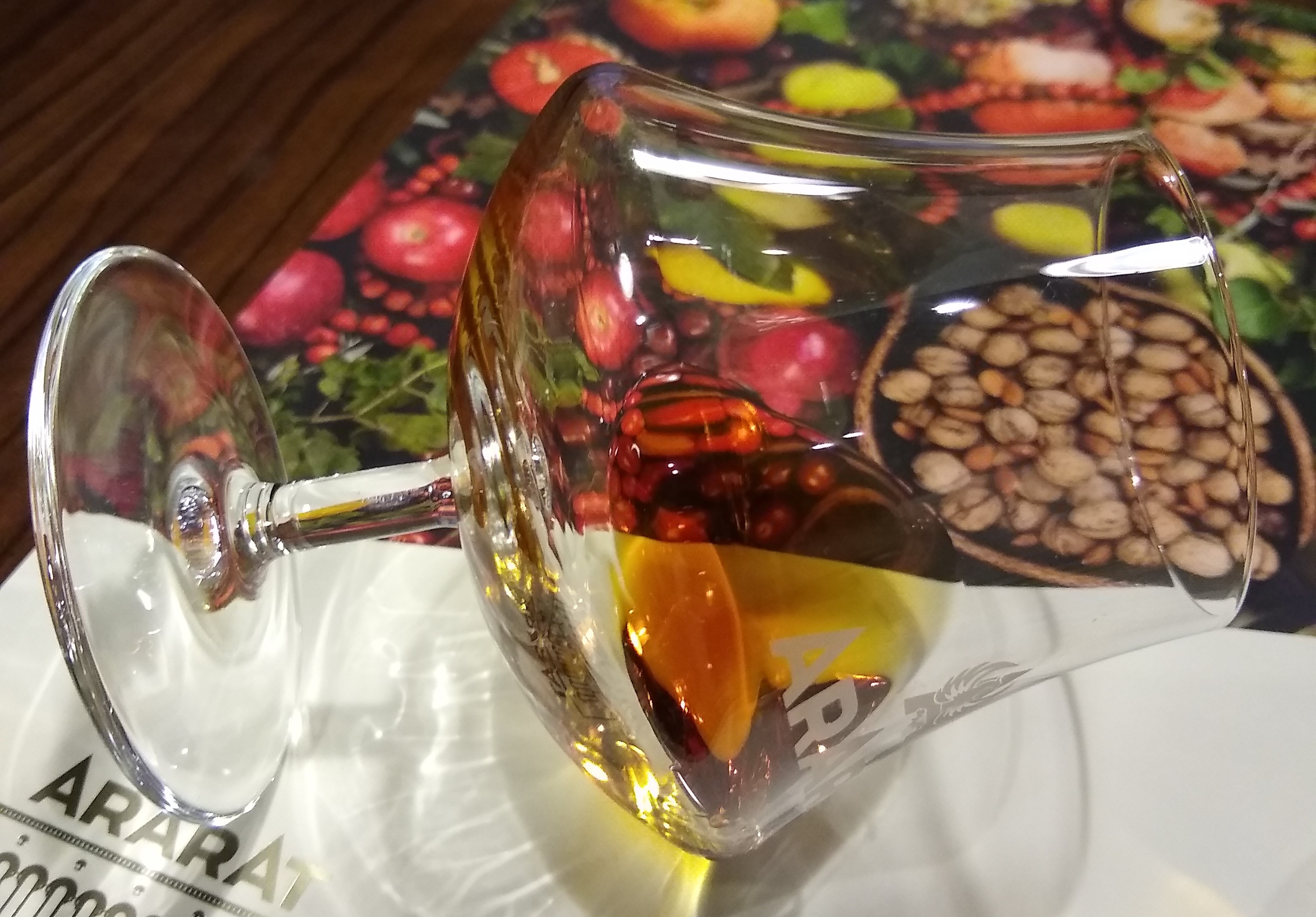 A photo of a brandy glass balanced on its side