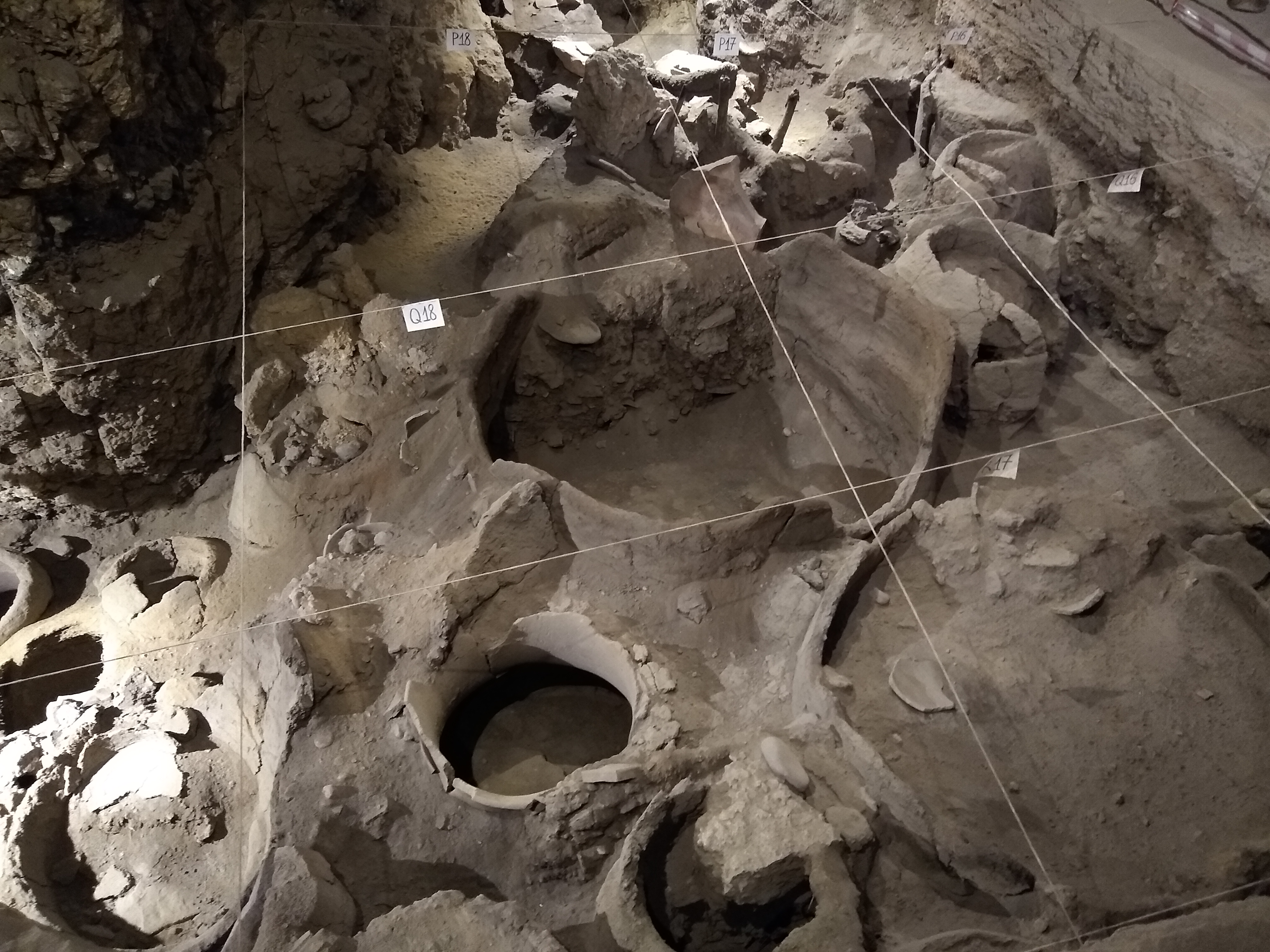 Photo of an archaeological site with large fermentation vessels