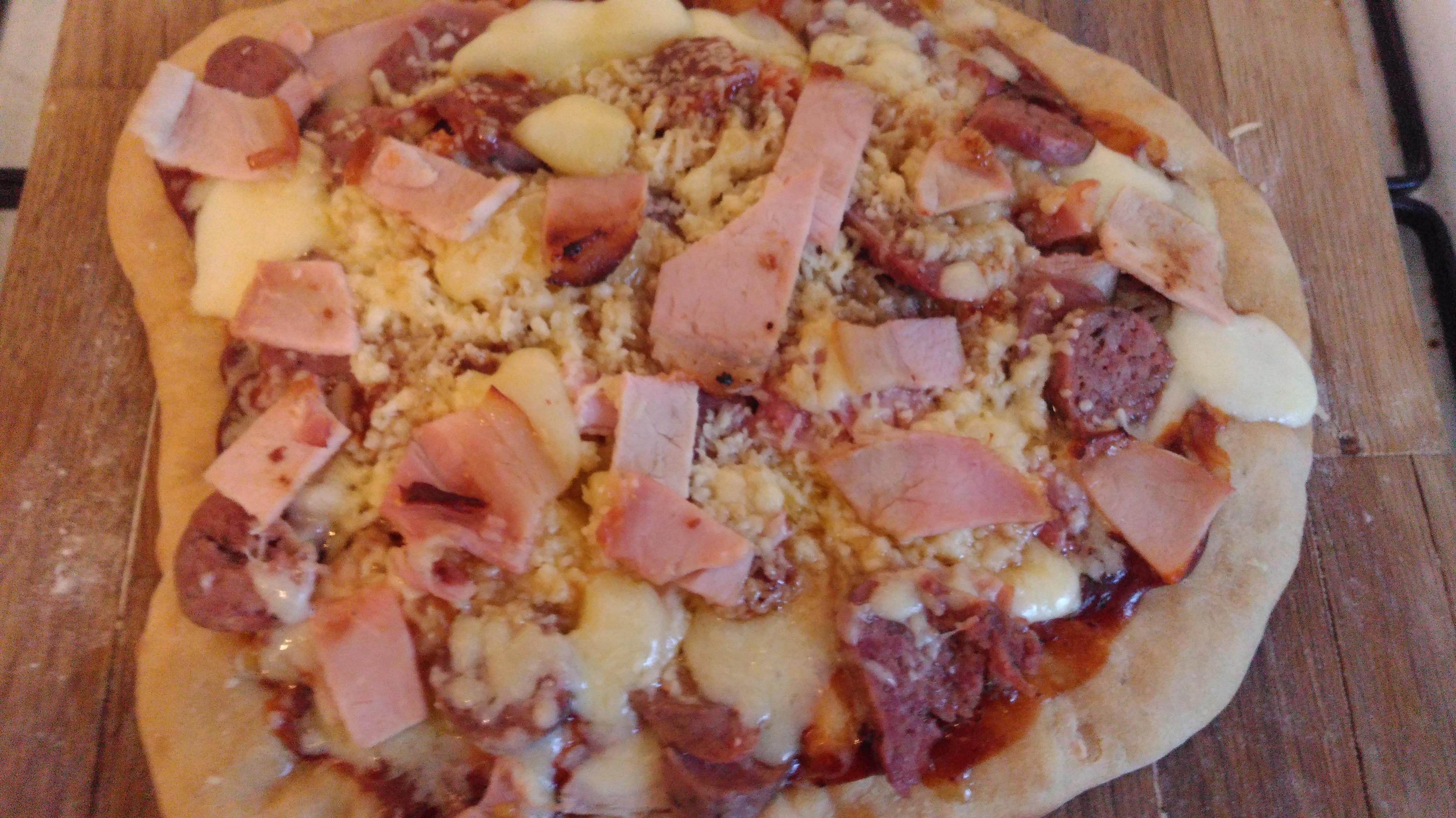A photograph of a pizza with lots of toppings