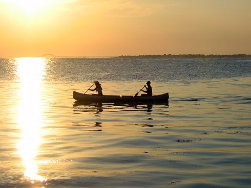 A photo of people relaxing in a canoe