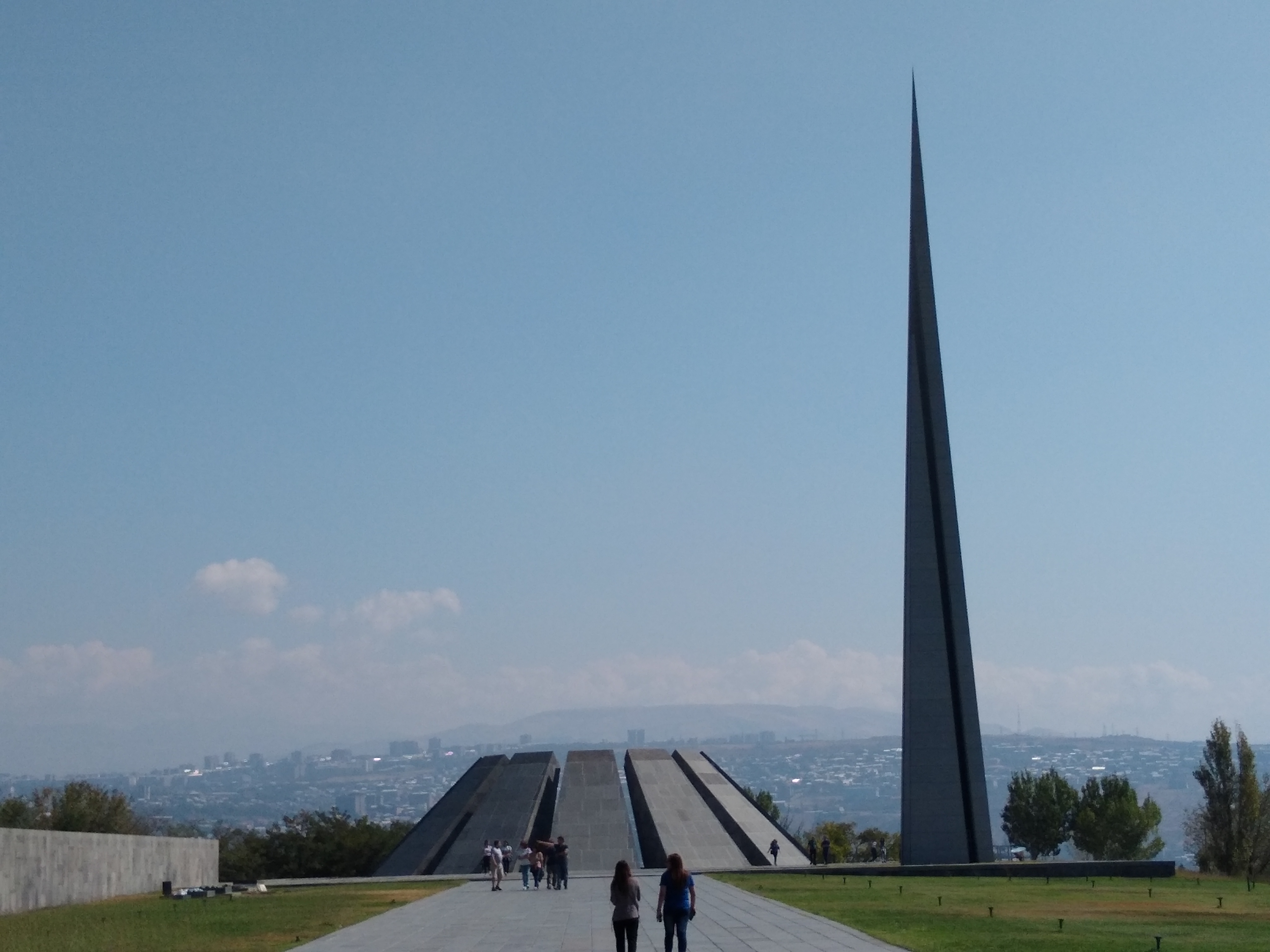 Photo of a pointed spire and a round dome of slabs of rock